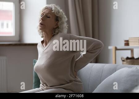 Frustrated senior woman suffering from rheumatism, radiculitis Stock Photo