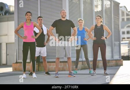 Group of diverse sports people practicing posing in the city Stock Photo