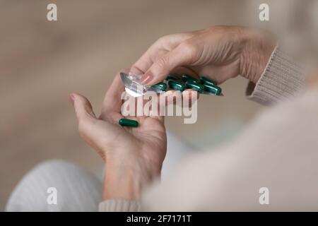 Senior lady taking daily dose of prescribed medication Stock Photo