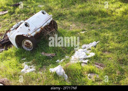 Abandoned crashed automobile in the countryside, rustic scene Stock Photo