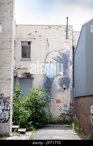 The Coronavirus inspired adaptation of Vermeer’s Girl With A Pearl Earing attributed to Banksy in Bristol, UK Stock Photo