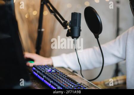 Closeup of two microphones on workplace of radio station. Man working indoors Stock Photo