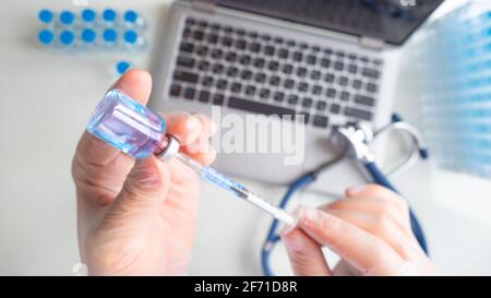 Vaccination research concept. Close-up of the doctor's hands as he draws a vaccine into a syringe. View from eyes of a doctor. Stock Photo
