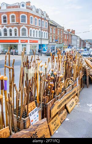 Display of walking sticks on the pavement outside a shop at the junction of East and West Street, Bridport, a market town in Dorset, south-west Englan Stock Photo