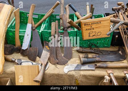 Display of tools for sale on the pavement outside a shop at the junction of East and West Street, Bridport, a market town in Dorset, south-west Englan Stock Photo