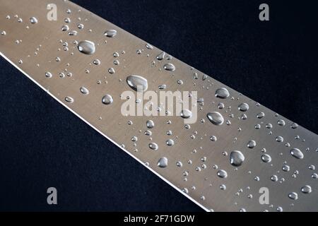 drops of water on a brushed steel surface. Stock Photo
