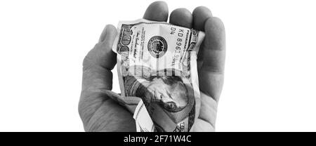 A crumpled hundred-dollar cash bill in his hand. Isolated on a white background. Stock Photo