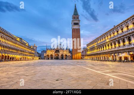 An empty St Marks square in Venice with the bell tower and the cathedral at dawn Stock Photo