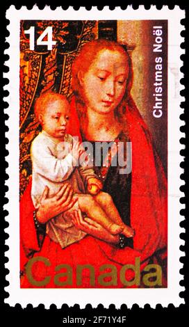 MOSCOW, RUSSIA - FEBRUARY 28, 2021: Postage stamp printed in Canada shows The Virgin and Child with Saint Anthony the Abbot and Donor, Christmas serie Stock Photo