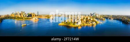 Wide aerial panorama of City of Sydney over Harbour waters around major CBD landmarks and North Shore. Stock Photo