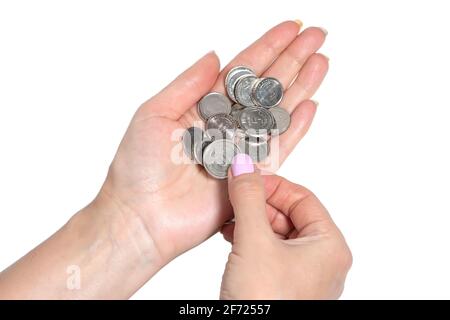 woman's hand holding Ukrainian coins isolated on white background. Stock Photo