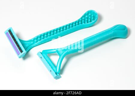 Cyan disposable razors isolated on white background. Stock Photo