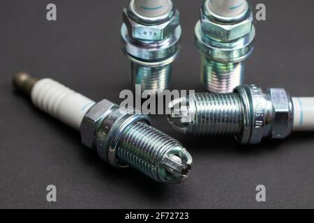 Spark plugs on black background. Car and motorcycle part. Stock Photo