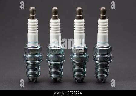 Spark plugs on black background. Car and motorcycle part. Stock Photo