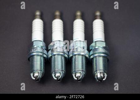Spark plugs on black background. Car and motorcycle part. Stock Photo