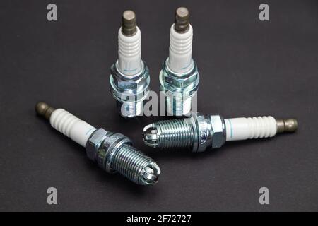 Spark plugs on black background. Car and motorcycle part. Stock Photo