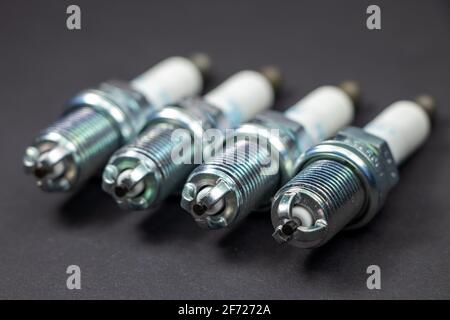 Spark plugs on black background. Car and motorcycle part. Stock Photo
