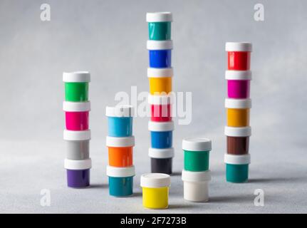 Collection of colorful cans of paint, on gray background Stock Photo