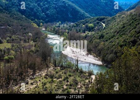 River meandering through forested landscape. View from the top to the cascades in the jungle. Panoramic view from above of mountain valley. River on a Stock Photo