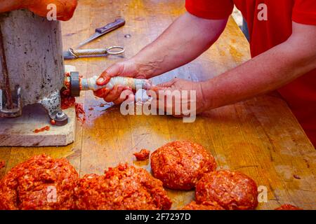 Fill up pig intestines to make sausage with machine for handmade sausages. Stock Photo