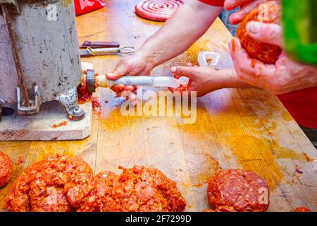 Fill up pig intestines to make sausage with machine for handmade sausages. Stock Photo