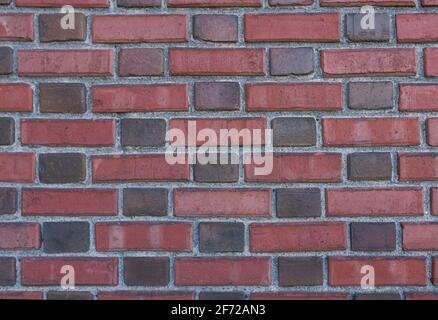 Brick wall made of red and burgundy bricks. Copying a space Stock Photo