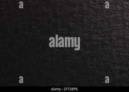 Black paper texture, grainy paper surface background, empty space photo Stock Photo