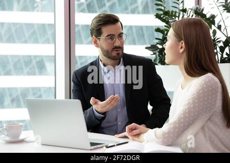 Businesspeople talk brainstorming using laptop at workplace Stock Photo