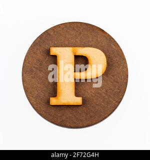 Letter P on a wood circle - Alphabet Stock Photo