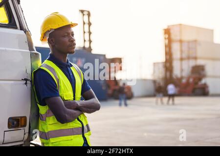 A black male worker standing in the trunk of a car Stock Photo