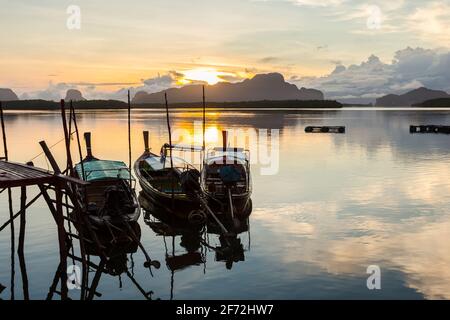 Ban Sam Chong Tai and colorful sunrises that emerges behind the giant limestone mountains, Phang-nga, Thailand Stock Photo