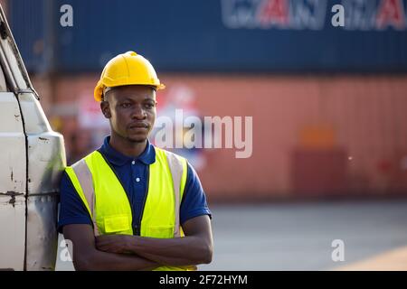 A black male worker standing in the trunk of a car Stock Photo