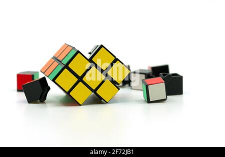 Bangkok, Thailand - Mar 31, 2021: Rubik's Cube that has fallen to the ground until it falls apart on white background. Stock Photo