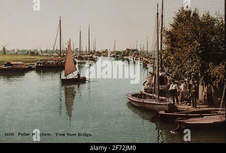 Hand-coloured postcard circa 1910 titled 'Potter Heigham. View from Bridge', showing the river Thurne at Potter Heigham in the Norfolk Broads. Stock Photo