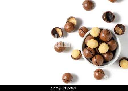 Peeled macadamia nuts in bowl isolated on white background, Macadamia nuts are loaded with flavonoids and tocotrienols and rich in heart-healthy monou Stock Photo
