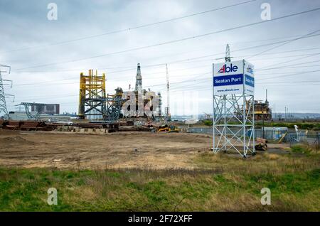 Able Seaton Port Sign and Topside deck of the Shell Brent Alpha Production platform and other structures during recycling at Able UK facility at Seato Stock Photo