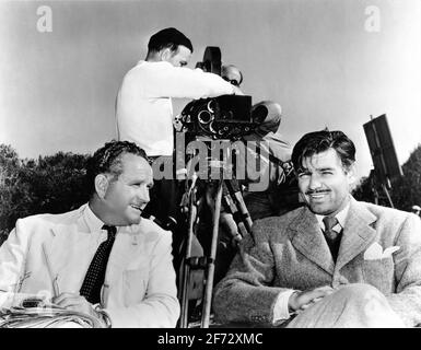 Director FRANK BORZAGE and CLARK GABLE on set location candid with Camera Crew during filming of STRANGE CARGO 1940 director FRANK BORZAGE Metro Goldwyn Mayer Stock Photo