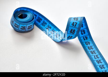 Blue measuring tape isolated on white background. Stock Photo