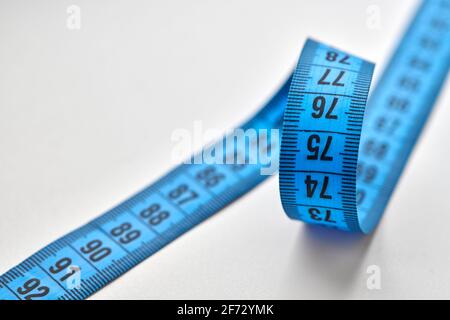 Blue measuring tape isolated on white background. Stock Photo