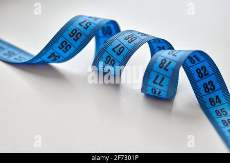 Blue measuring tape isolated on white background. Stock Photo