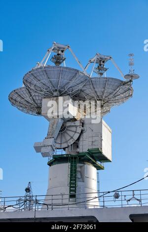 Navigation and radar equipment and antenna on mast of ship. Mast of large yacht with navigation equipment, bottom view. Radar, signal lights and satel Stock Photo