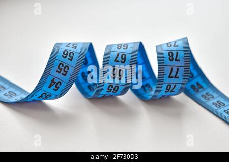 Blue measuring tape isolated on white background. Stock Photo