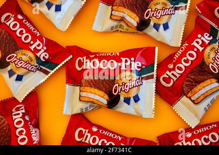Tambov, Russian Federation - October 30, 2020 Some Orion Choco-Pie snack cakes on yellow background. Stock Photo