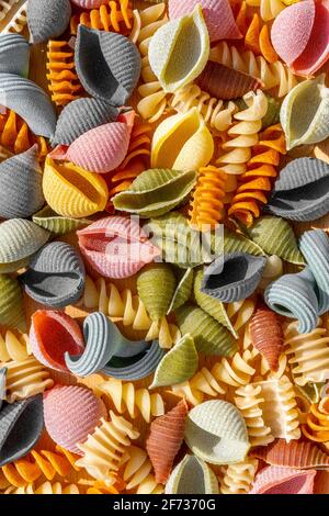 Different types of Italian colorful dry pasta as background. Macro close up. Stock Photo