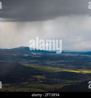 Mount Jested in the Bohemian Lusatian Mountains as seen from Mount Hochwald with storm clouds and rain plumes Stock Photo