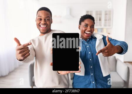Black couple showing blank empty tablet screen for mock up Stock Photo
