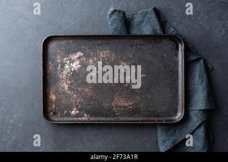 Old rusty black baking sheet background, top view, copy space Stock Photo
