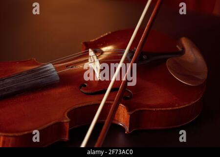Violin in retro style and bow, closeup view Stock Photo