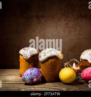 Easter cakes and Easter colored eggs on a dark background. Religious holiday of bright Easter. Stock Photo