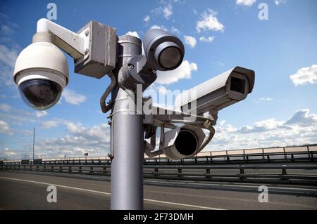 CCTV Security Camera or surveillance operating on traffic road and urban scene. Stock Photo